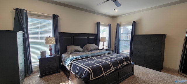 carpeted bedroom with ornamental molding and ceiling fan