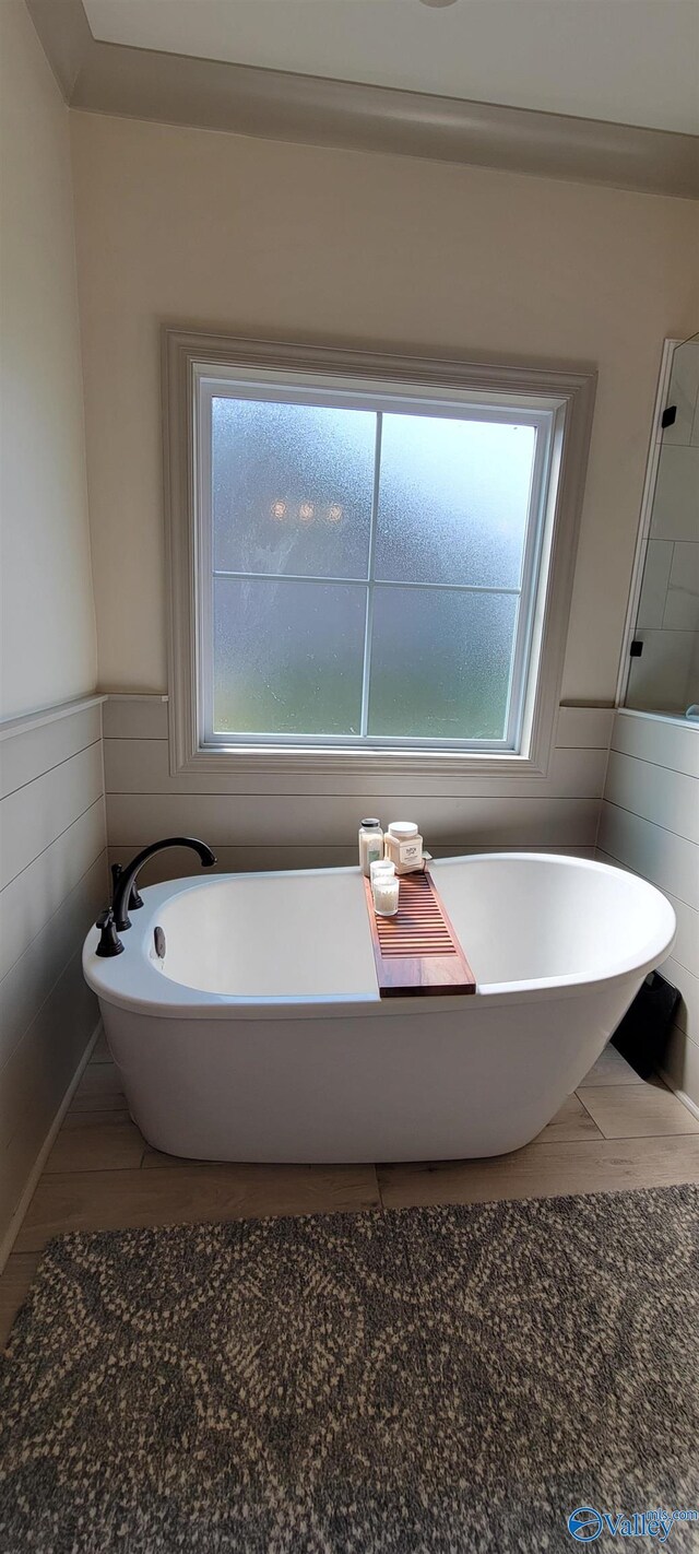 bathroom with tile walls and a tub