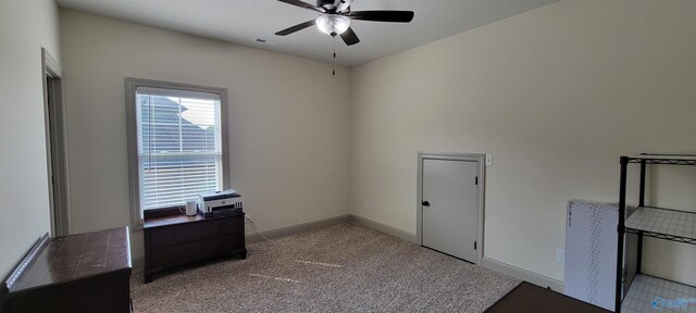 interior space featuring ceiling fan and light carpet