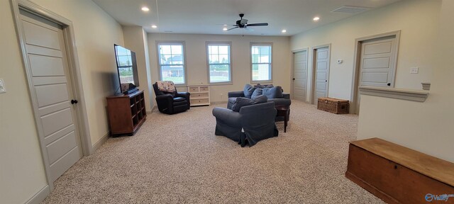 sitting room featuring light carpet and ceiling fan