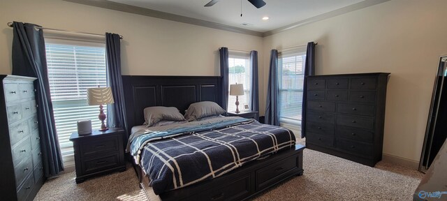 bedroom with ceiling fan, light carpet, and crown molding