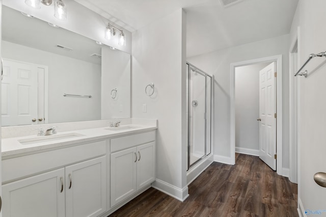 bathroom featuring vanity, hardwood / wood-style flooring, and an enclosed shower