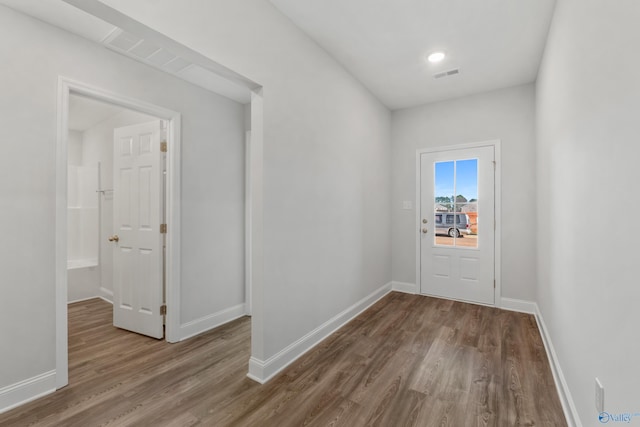 doorway to outside with wood-type flooring