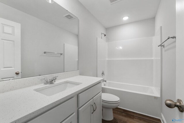 full bathroom featuring hardwood / wood-style floors, toilet, vanity, and  shower combination