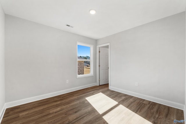 unfurnished room featuring dark wood-type flooring