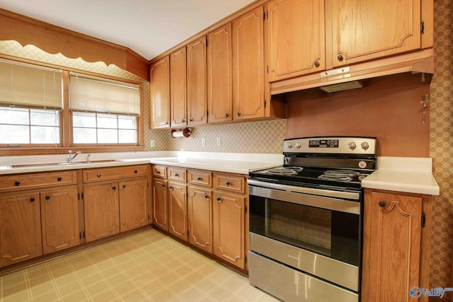 kitchen with stainless steel electric range, sink, and tasteful backsplash