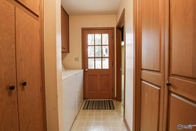 washroom with separate washer and dryer and cabinets