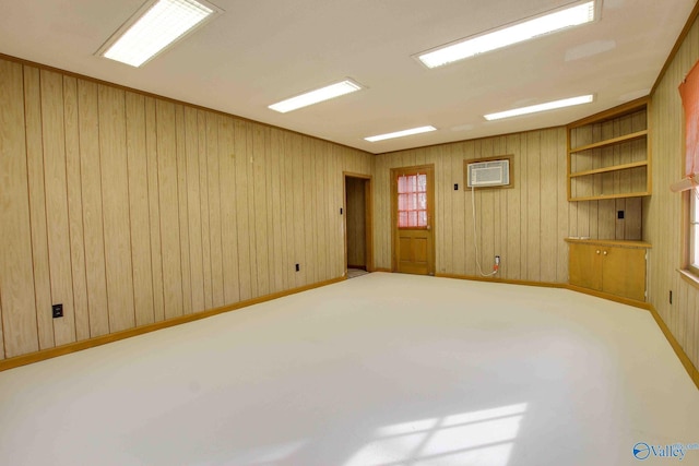 unfurnished room with carpet flooring and wood walls