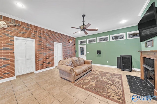 tiled living area with ornamental molding, baseboards, a fireplace, and brick wall