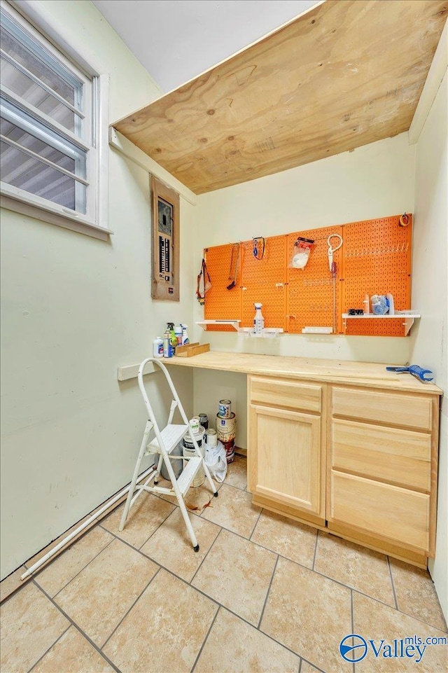 kitchen with wood ceiling, light tile patterned flooring, and light brown cabinetry