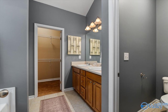 bathroom with vanity, toilet, and tile patterned floors