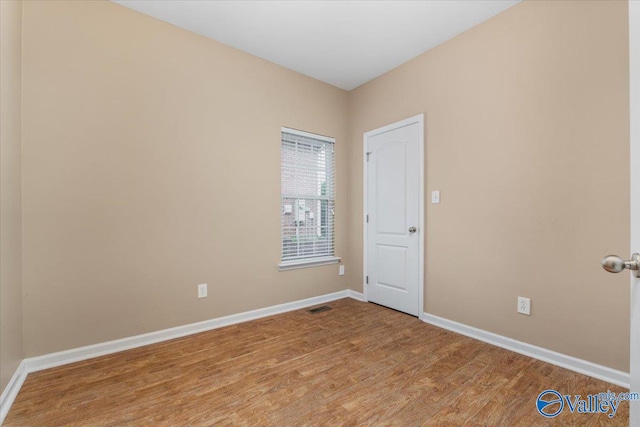 unfurnished room featuring wood-type flooring