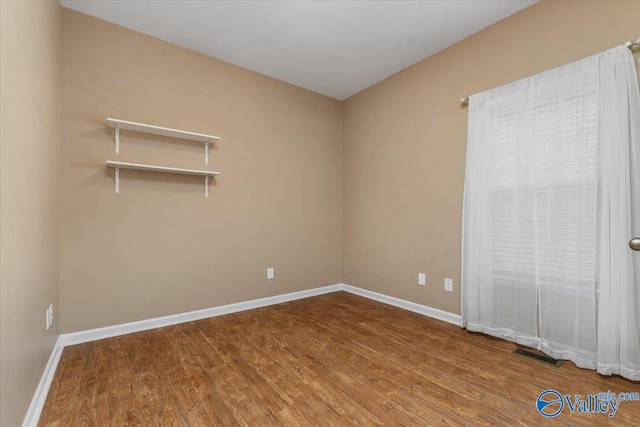 spare room with hardwood / wood-style flooring