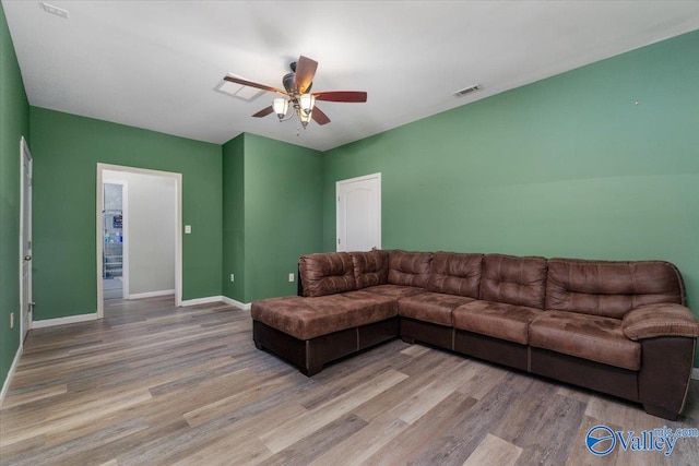 living room featuring ceiling fan and light hardwood / wood-style flooring