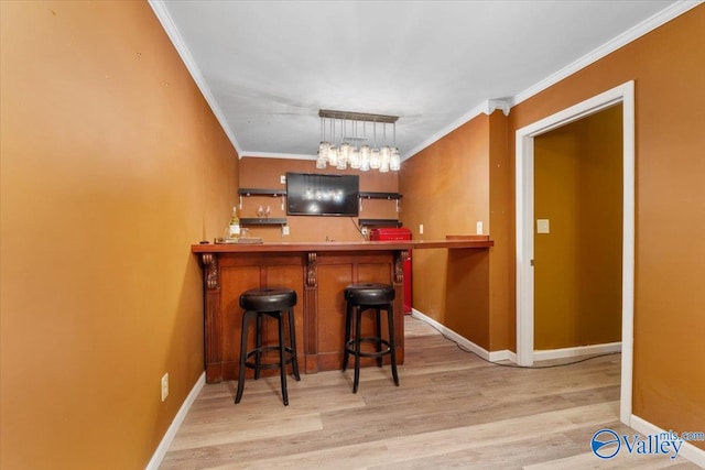 interior space with light wood-type flooring, hanging light fixtures, and crown molding