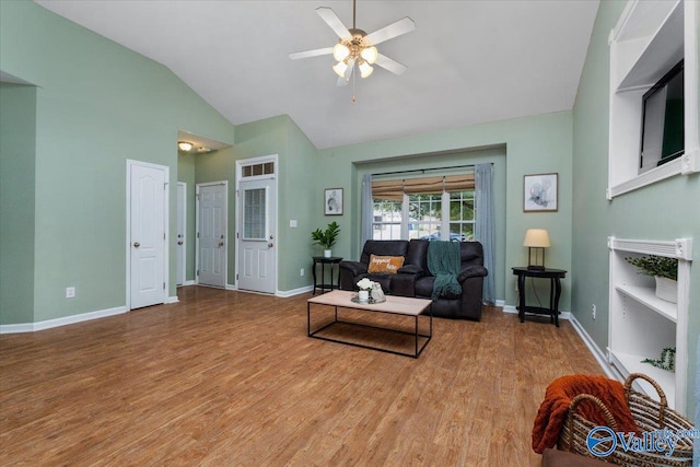 living room with light hardwood / wood-style floors, vaulted ceiling, and ceiling fan