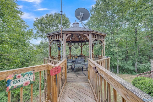 view of dock with a wooden deck and a gazebo