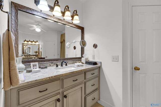 bathroom with ceiling fan, ornamental molding, and vanity