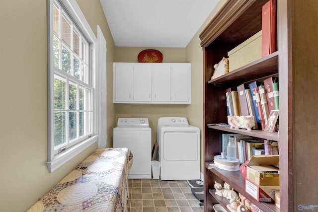 clothes washing area featuring independent washer and dryer, cabinets, and a healthy amount of sunlight