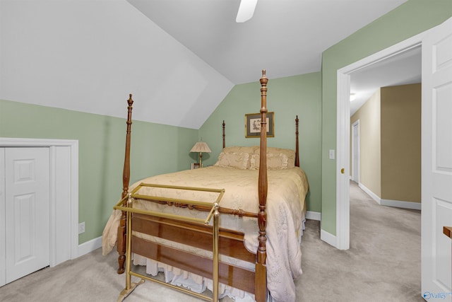 bedroom featuring a closet, ceiling fan, vaulted ceiling, and light carpet