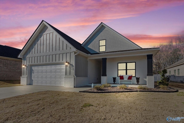 view of front of home with covered porch and a garage