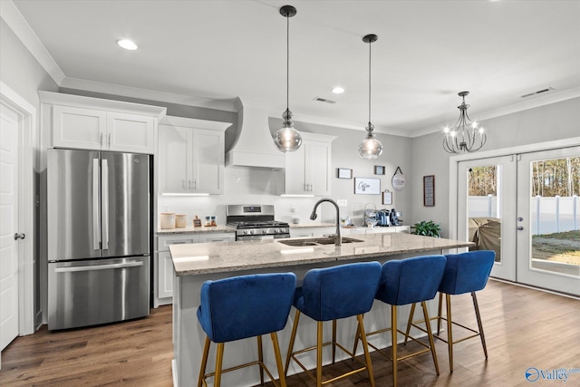 kitchen featuring french doors, white cabinets, sink, custom range hood, and stainless steel appliances