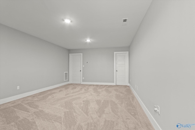 empty room with light colored carpet