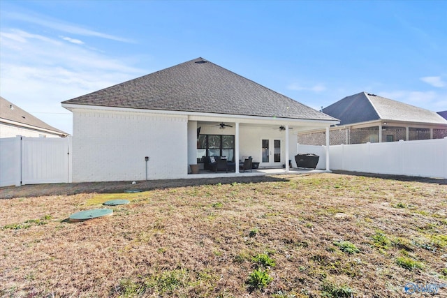 back of house featuring ceiling fan, a yard, a patio, and french doors