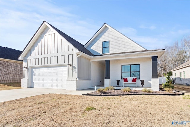 view of front facade featuring a front yard, a porch, and a garage