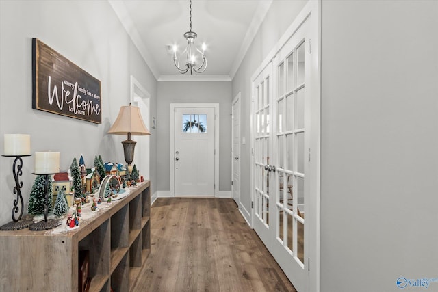 doorway to outside with a chandelier, wood-type flooring, french doors, and crown molding