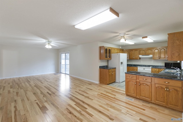 kitchen featuring white refrigerator with ice dispenser, kitchen peninsula, ceiling fan, and light hardwood / wood-style flooring