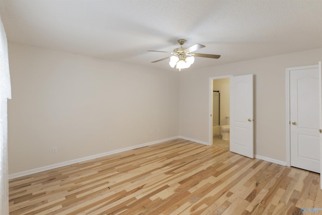 unfurnished bedroom with ceiling fan, a textured ceiling, light hardwood / wood-style floors, and ensuite bath