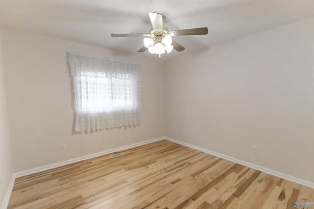 unfurnished room with ceiling fan, light hardwood / wood-style floors, and a textured ceiling