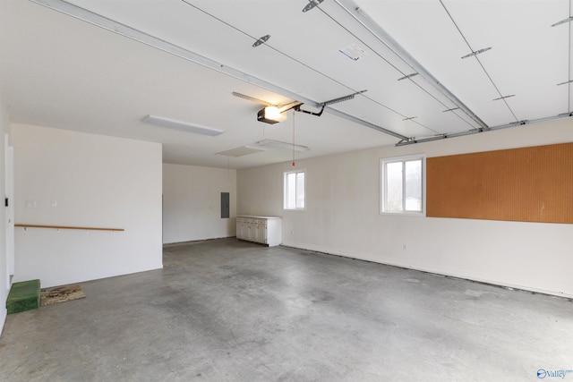 garage with a garage door opener and electric panel