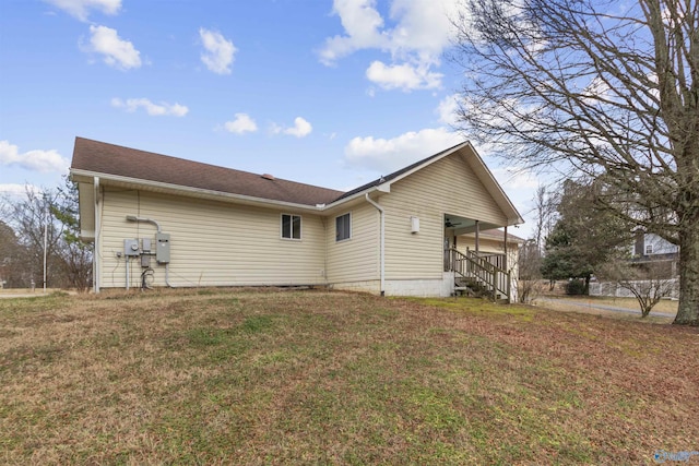 rear view of house with a lawn