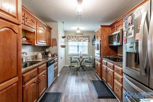 kitchen with brown cabinets, a sink, and stainless steel appliances