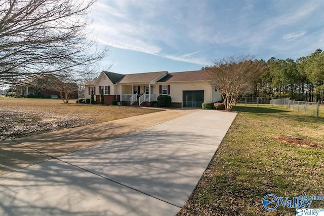 single story home featuring fence, an attached garage, driveway, a front yard, and a porch