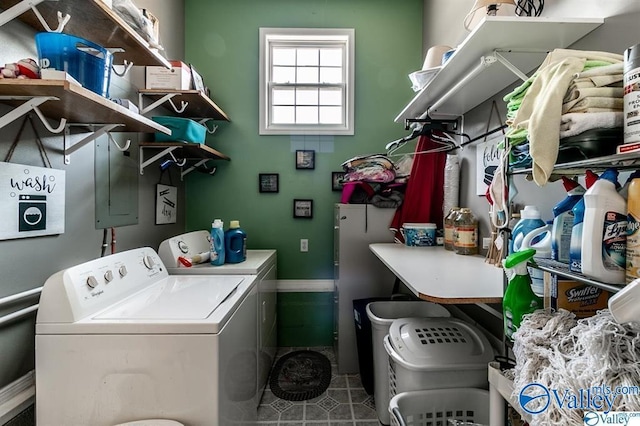 laundry room featuring independent washer and dryer, tile patterned floors, baseboards, and laundry area