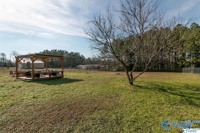view of yard featuring fence and a pergola