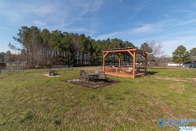 view of yard with a pergola, fence, and a deck