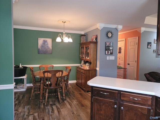 dining space featuring ornamental molding, a notable chandelier, and dark hardwood / wood-style flooring