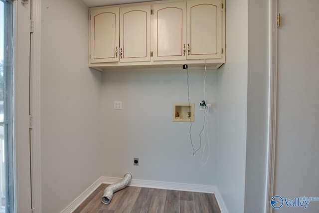 laundry room with cabinets, wood-type flooring, hookup for an electric dryer, and hookup for a washing machine