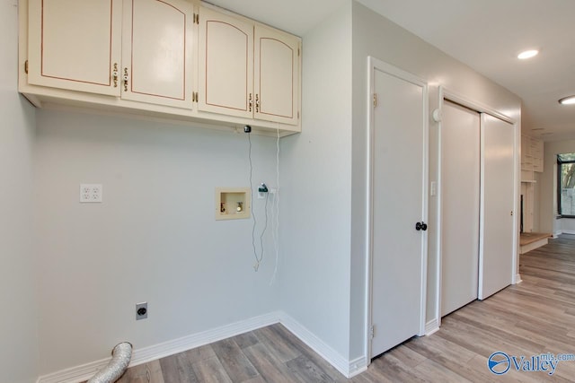 washroom with hookup for a washing machine, hookup for an electric dryer, cabinets, and light hardwood / wood-style floors