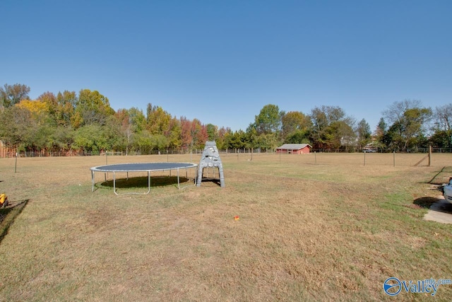 view of yard with a rural view and a trampoline