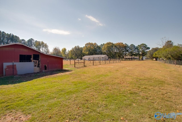 view of yard with an outbuilding and a rural view