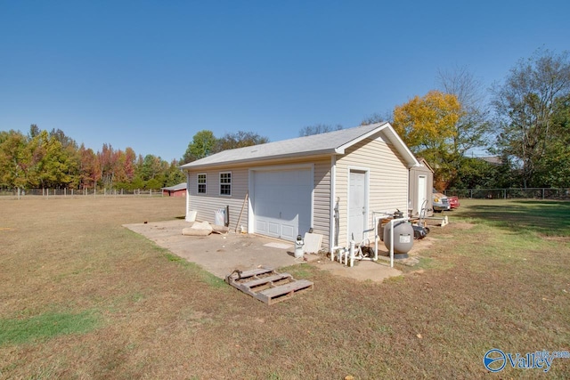 view of property exterior with an outbuilding, a garage, and a lawn