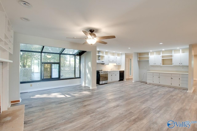 unfurnished living room with ceiling fan and light hardwood / wood-style flooring