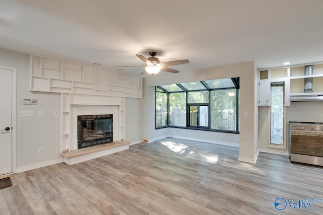 unfurnished living room featuring ceiling fan and light hardwood / wood-style floors