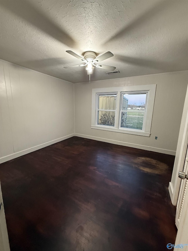 spare room with visible vents, a textured ceiling, baseboards, and ceiling fan