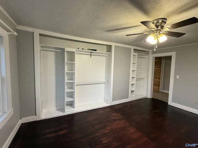 unfurnished bedroom featuring baseboards, a textured ceiling, ceiling fan, and wood finished floors